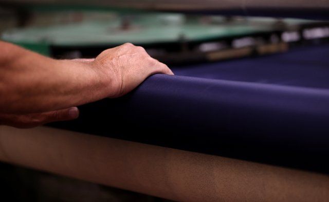 (220812) -- MACCLESFIELD, Aug. 12, 2022 (Xinhua) -- A man works in Adamley Textiles, a silk factory, in Macclesfield, Britain, Aug. 11, 2022. Macclesfield, once famous for its weaving industry, is known as the "silk capital of England". On the height of prosperity, a total of 71 silk mills were in operation in 1832. (Xinhua\/Li Ying