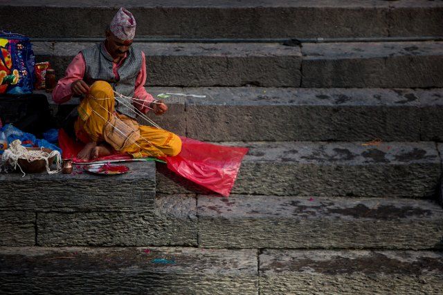 (220812) -- KATHMANDU, Aug. 12, 2022 (Xinhua) -- A priest arranges the Janai during the Janai Purnima festival on the premises of Pashupatinath Temple in Kathmandu, Nepal, Aug. 12, 2022. During this festival, Hindus take holy bath and perform annual change of the Janai, a sacred cotton string worn around their chest or tied on the wrist, in the belief that it will protect and purify them. (Photo by Sulav Shrestha\/Xinhua