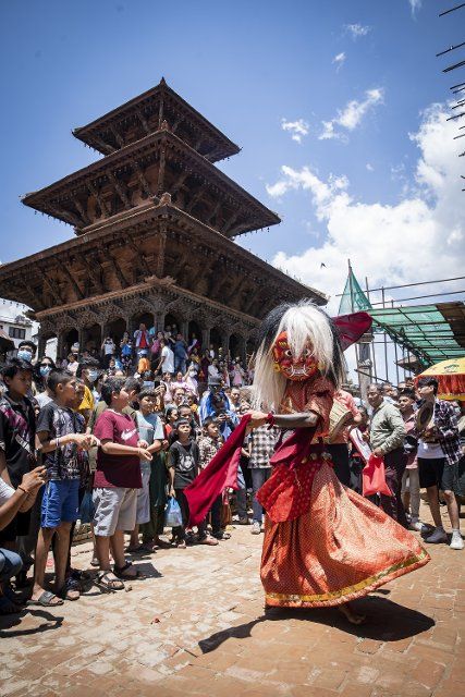 (220812) -- LALITPUR, Aug. 12, 2022 (Xinhua) -- An artist performs the Lakhe dance during the procession of the annual Gai Jatra, or Cow Festival, in Lalitpur, Nepal, Aug. 12, 2022. The festival is celebrated mainly by the Newar community in the Kathmandu Valley to commemorate their family members who have passed away in the past year. Children participating in the procession often dress as cows, which is believed to be a holy animal to assist departed souls to reach heaven. (Photo by Hari Maharjan\/Xinhua