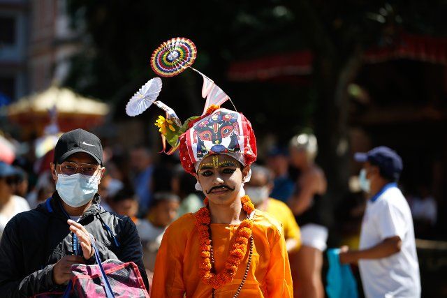 (220812) -- KATHMANDU, Aug. 12, 2022 (Xinhua) -- A boy wearing festive costumes participates in the procession of the annual Gai Jatra, or Cow Festival, in Kathmandu, Nepal, Aug. 12, 2022. The festival is celebrated mainly by the Newar community in the Kathmandu Valley to commemorate their family members who have passed away in the past year. Children participating in the procession often dress as cows, which is believed to be a holy animal to assist departed souls to reach heaven. (Photo by Sulav Shrestha\/Xinhua