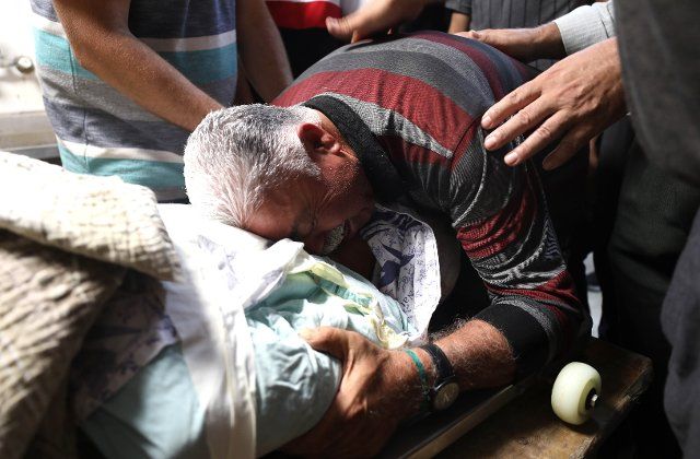 (220819) -- NABLUS, Aug. 19, 2022 (Xinhua) -- A relative of Palestinian Salah Sawafta mourns over his body at a hospital in the West Bank city of Nablus, Aug. 19, 2022. Salah Sawafta, 58, died from critical injuries after being shot in the head by Israeli soldiers in the West Bank city of Tubas, the Palestinian health ministry said. (Photo by Ayman Nobani\/Xinhua