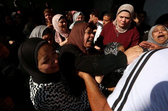 (220819) -- NABLUS, Aug. 19, 2022 (Xinhua) -- Relatives of Palestinian young man Wasim Khalifa, mourn during his funeral, in the West Bank city of Nablus, on Aug. 18, 2022. The Palestinian Ministry of Health said in a statement that Wasim Khalifa, 18, was shot in the chest by Israeli soldiers and died right after he was brought to Nablus Hospital. (Photo by Nidal Eshtayeh\/Xinhua