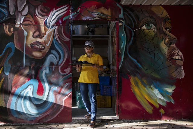 (220819) -- NEW DELHI, Aug. 19, 2022 (Xinhua) -- A survivor of acid attack carries tea for customers at Sheroes Hangout cafe in Noida on the outskirts of New Delhi, India, Aug. 19, 2022. Sheroes Hangout is a cafe run by survivors of acid attacks. The cafe aims at empowering acid attack survivors, as well as raising awareness on the acid attacks. The cafe provides job opportunities for acid attack victims. (Xinhua\/Javed Dar