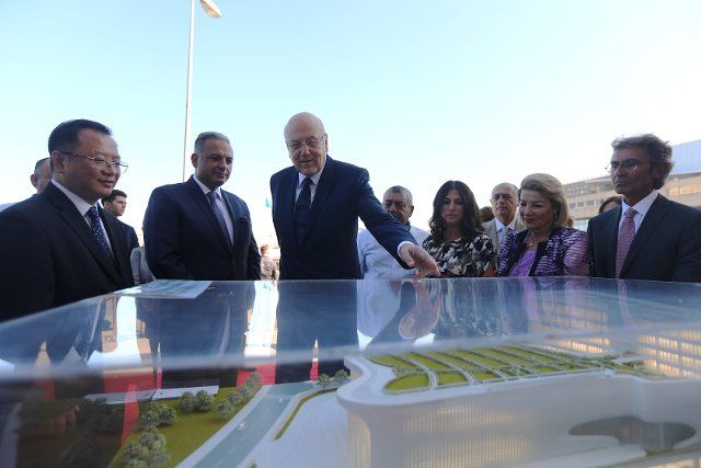 (221006) -- BEIRUT, Oct. 6, 2022 (Xinhua) -- Lebanese Prime Minister Najib Mikati (3rd L) looks at the model of China-funded National Higher Conservatory of Music during his visit to the construction site of the conservatory in Dbayeh, near Beirut, Lebanon, Oct. 6, 2022. The Lebanese National Higher Conservatory of Music funded by the Chinese government near Lebanon\