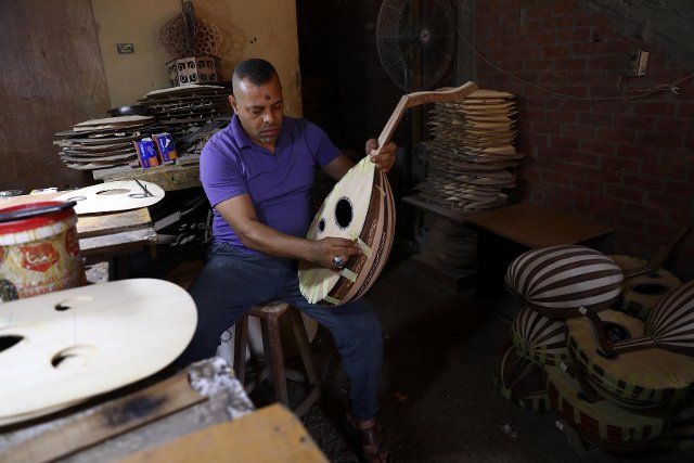 (221007) -- CAIRO, Oct. 7, 2022 (Xinhua) -- A worker makes an oud at a workshop in Cairo, Egypt, Sept. 27, 2022. TO GO WITH "Feature: Egyptian oud, Chinese pipa show cultural communication through music" (Xinhua\/Ahmed Gomaa