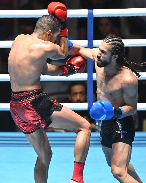 (220925) -- KUWAIT, Sept. 25, 2022 (Xinhua) -- Muhannad Almughrabi (L) of Lebanon and Omar Mansour of Jordan fight in a Pro Muay Thai match during the first Kuwait Championship for Amateur and Professional Martial Arts in Mubarak Al-Kabeer Governorate, Kuwait, Sept. 24, 2022. (Photo by Asad\/Xinhua