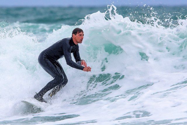 (220926) -- LIZNJAN, Sept. 26, 2022 (Xinhua) -- A man surfs at Beach Marlera in Liznjan, Croatia on Sept. 25, 2022. (Srecko Niketic\/PIXSELL via Xinhua