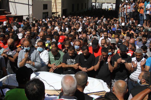 (220926) -- BEIRUT, Sept. 26, 2022 (Xinhua) -- Palestinians pray for a man, one of the victims of the migrant boat that sank off the Syrian shore last Thursday, during a funeral at the Nahr al-Bared camp in northern Lebanon, Sept. 25, 2022. (Photo by Khaled Habashiti\/Xinhua