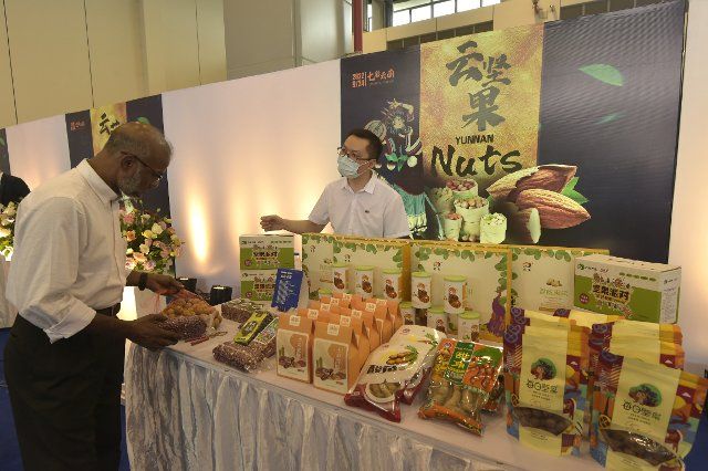 (220926) -- DHAKA, Sept. 26, 2022 (Xinhua) -- A visitor looks at nut products during the Colorful Yunnan exhibition in Dhaka, Bangladesh, Sept. 24, 2022. The exhibition, held at Bangabandhu Bangladesh-China Friendship Exhibition Center in Dhaka on Saturday, showcased Yunnan\