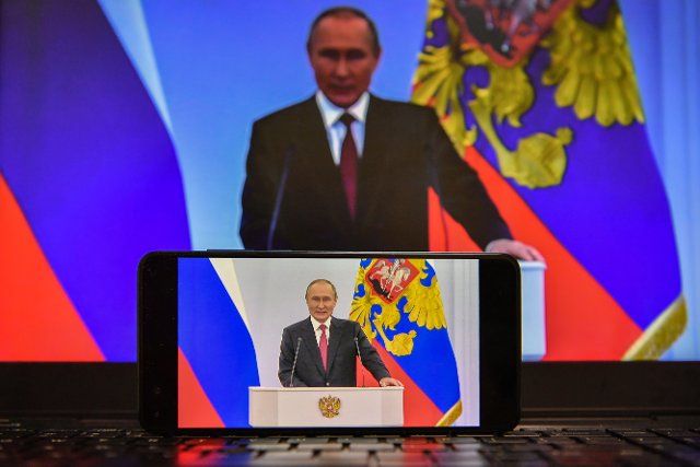 (220930) -- MOSCOW, Sept. 30, 2022 (Xinhua) -- Photo taken on Sept. 30, 2022 shows screens displaying Russian President Vladimir Putin delivering a speech in Moscow, Russia. TO GO WITH "Ceremony held on Donetsk, Lugansk, Zaporizhzhia, Kherson joining Russia" (Xinhua\/Cao Yang