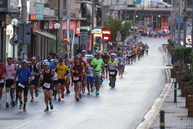 (221001) -- ATHENS, Oct. 1, 2022 (Xinhua) -- Athletes compete during the Spartathlon ultramarathon in Athens, Greece, Sept. 30, 2022. TO GO WITH "40th Spartathlon ultramarathon race kicks off at foot of Athens Acropolis". (Photo by Lefteris Partsalis\/Xinhua