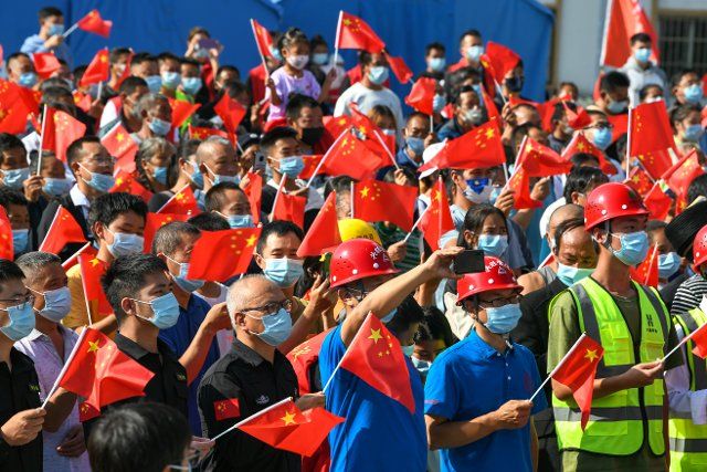 (221001) -- LUDING, Oct. 1, 2022 (Xinhua) -- People attend a flag-raising ceremony to celebrate the 73rd anniversary of the founding of the People\