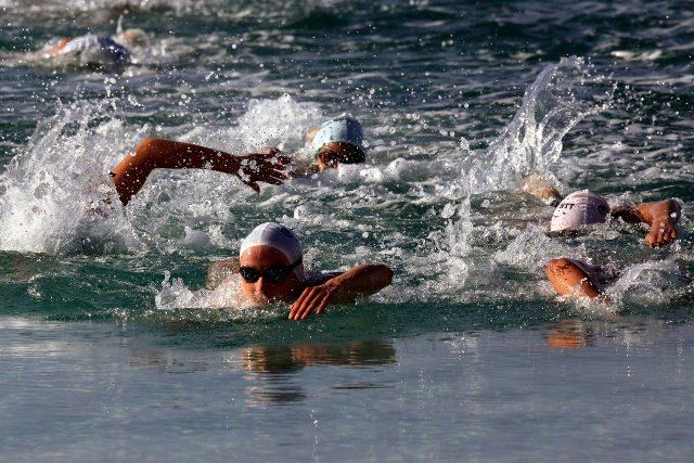 (221002) -- AQABA, Oct. 2, 2022 (Xinhua) -- Athletes compete in the swimming game during the 2022 Asia Triathlon Cup Aqaba in the southern port city of Aqaba, Jordan, on Oct. 1, 2022. (Photo by Mohammad Abu Ghosh\/Xinhua