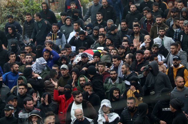 (221129) -- BEIT UMMAR, Nov. 29, 2022 (Xinhua) -- Mourners carry the body of a Palestinian killed in clashes with Israeli soldiers during his funeral in the village of Beit Ummar in the north of the West Bank city of Hebron, on Nov. 29, 2022. Five Palestinians were killed in clashes with Israeli soldiers in four separate incidents in the West Bank, prompting condemnation and calls for stopping the Israeli violence against Palestinians. (Photo by Mamoun Wazwaz\/Xinhua