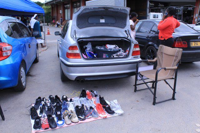(221201) -- GABORONE, Dec. 1, 2022 (Xinhua) -- A parked vehicle with its boot wide open serves as a shop along Haskins Street in Francistown, Botswana, Nov. 29, 2022. Along busy streets and junctions in Francistown, Botswana\