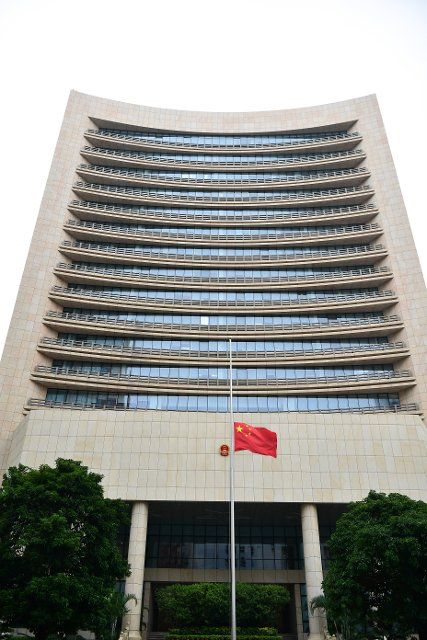 (221201) -- MACAO, Dec. 1, 2022 (Xinhua) -- A Chinese national flag is flown at half-mast to mourn the death of Comrade Jiang Zemin at the Liaison Office of the Central People\