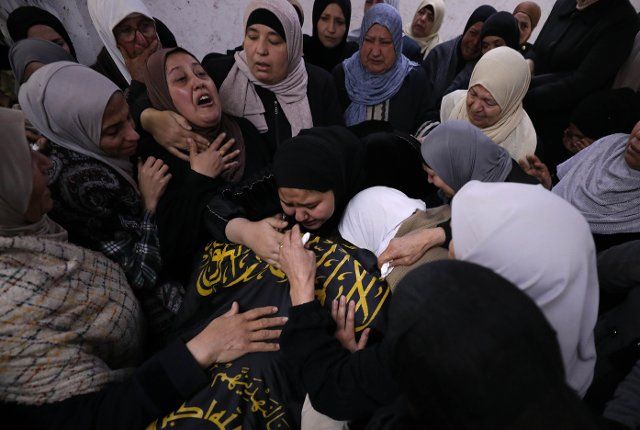 (221201) -- JENIN, Dec. 1, 2022 (Xinhua) -- People mourn during a funeral in the West Bank city of Jenin, on Dec. 1, 2022. Two Palestinian militants were killed on Thursday during clashes with Israeli soldiers in the Jenin refugee camp in the northern West Bank, Palestinian medics and local sources said. (Photo by Ayman Nobani\/Xinhua