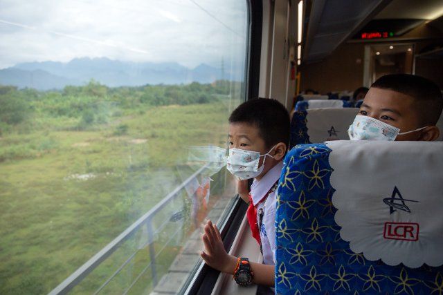 (221204) -- VIENTIANE, Dec. 4, 2022 (Xinhua) -- Students from the China-Laos Friendship Nongping Primary School are seen on the Lane Xang EMU train in Laos, Dec. 1, 2022. TO GO WITH "Lao deputy PM hails Laos-China Railway as pride of Laos" (Photo by Kaikeo Saiyasane\/Xinhua