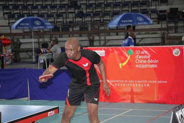 (221205) -- COTONOU, Dec. 5, 2022 (Xinhua) -- A player competes in a table tennis match as part of the celebration of 50 years of friendship between China and Benin, in Cotonou, Benin, Dec. 4, 2022. (Photo by Seraphin Zounyekpe\/Xinhua