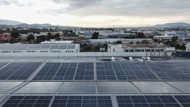 (221206) -- ATHENS, Dec. 6, 2022 (Xinhua) -- This aerial photo taken on Nov. 29, 2022 shows photovoltaic installations at the rooftop of Stergiou Family S.A. factory in Acharnes, a suburb of Athens, Greece. Facing soaring electricity and natural gas bills, Greek companies and households are turning to photovoltaics en masse this year to cope with the ongoing energy crisis. TO GO WITH "Feature: Greek businesses, households shift to solar power as energy bills soar" (Photo by Lefteris Partsalis\/Xinhua