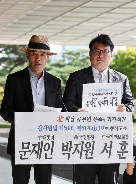 Complaint against ex-President Moon Jae-in Lee Rae-jin (L), the elder brother of a South Korean official shot to death by North Korean soldiers while drifting in waters in the West Sea in September 2020, and his lawyer, Kim Ki-yoon, hold a news conference in front of the Seoul Central Prosecutors Office in Seoul on Oct. 7, 2022, prior to filing a complaint against former President Moon Jae-in, former National Intelligence Service chief Park Jie-won and former National Security Adviser Suh Hoon for having not complied with the Board of Audit and Inspection\