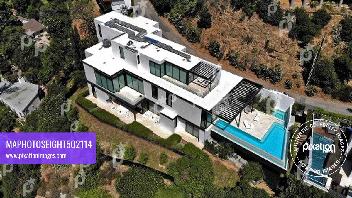 Ariana Grande purchases this $13.7 million Mega Mansion in the Hollywood Hills, The 10,000 square foot home has 4 bedrooms, 7 bathrooms, a wellness, 300 bottle wine cellar, a bar and a office