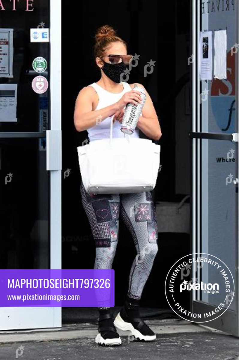 Jennifer Lopez shows off her guns and midriff leaving her gym in Miami