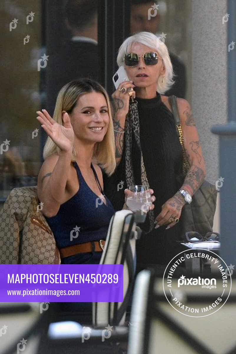 Michelle Hunziker seen in Milan with her friend Simona Quaranta and her manager, wearing a Gucci jacket and carrying a Gucci purse