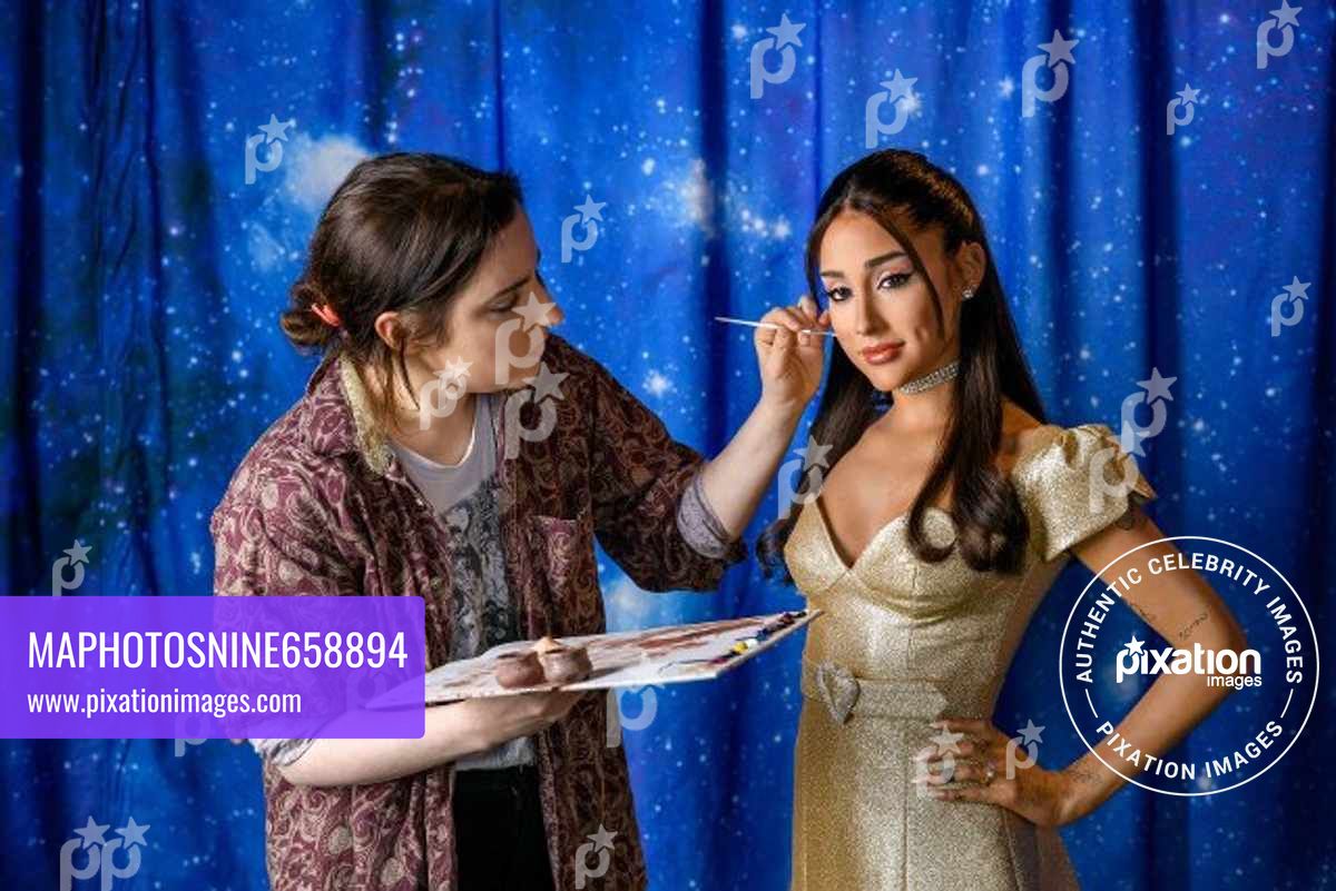Fans pose with wax figures of music superstars including Ariana Grande, Dua Lipa and David Bowie in Madame Tussauds London’s revamped Music Festival zone