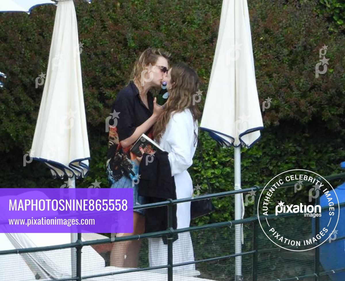 Cara Delevingne, wearing a t-shirt with Bob Marley's picture, seen kissing a new girlfriend singer Minke in the park of Hotel Splendido in Portofino