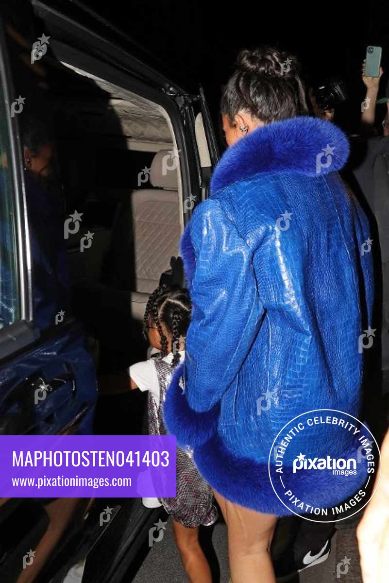 Kylie Jenner and daughter Stormi wow fans as they leave their hotel wearing an oversized blue crocodile skin and fur coat, with a very leggy display