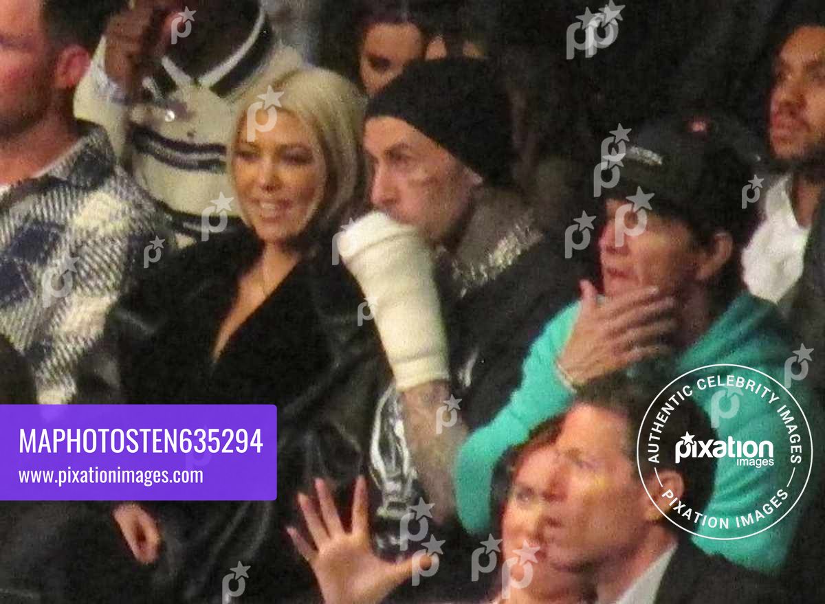 Kourtney Kardashian spotted with new blonde hair look as she shows off her curves with injured Travis Barker as they watch UFC fight in vip row with Tom Brady and Mark Wahlberg in Las Vegas
