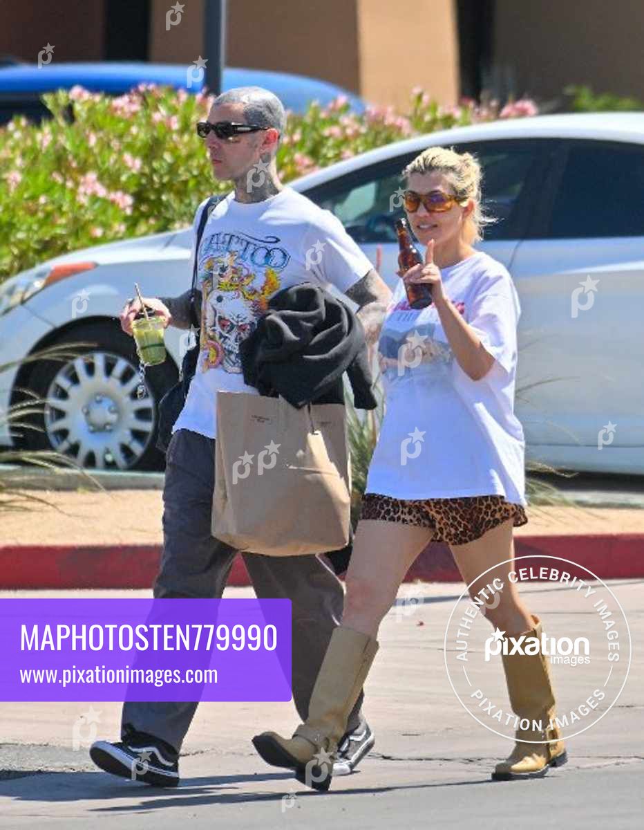 Kourtney Kardashian and husband Travis Barker are all smiles as they leave a vegan restaurant in Palm Desert after celebrating their 1st wedding anniversary