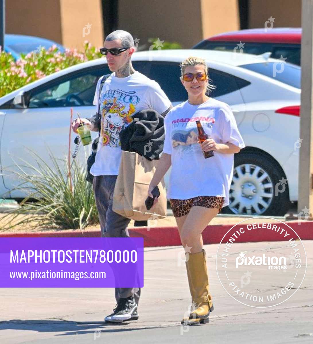 Kourtney Kardashian and husband Travis Barker are all smiles as they leave a vegan restaurant in Palm Desert after celebrating their 1st wedding anniversary