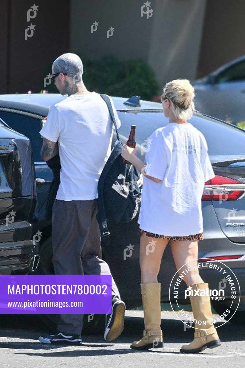 Kourtney Kardashian and husband Travis Barker are all smiles as they leave a vegan restaurant in Palm Desert after celebrating their 1st wedding anniversary