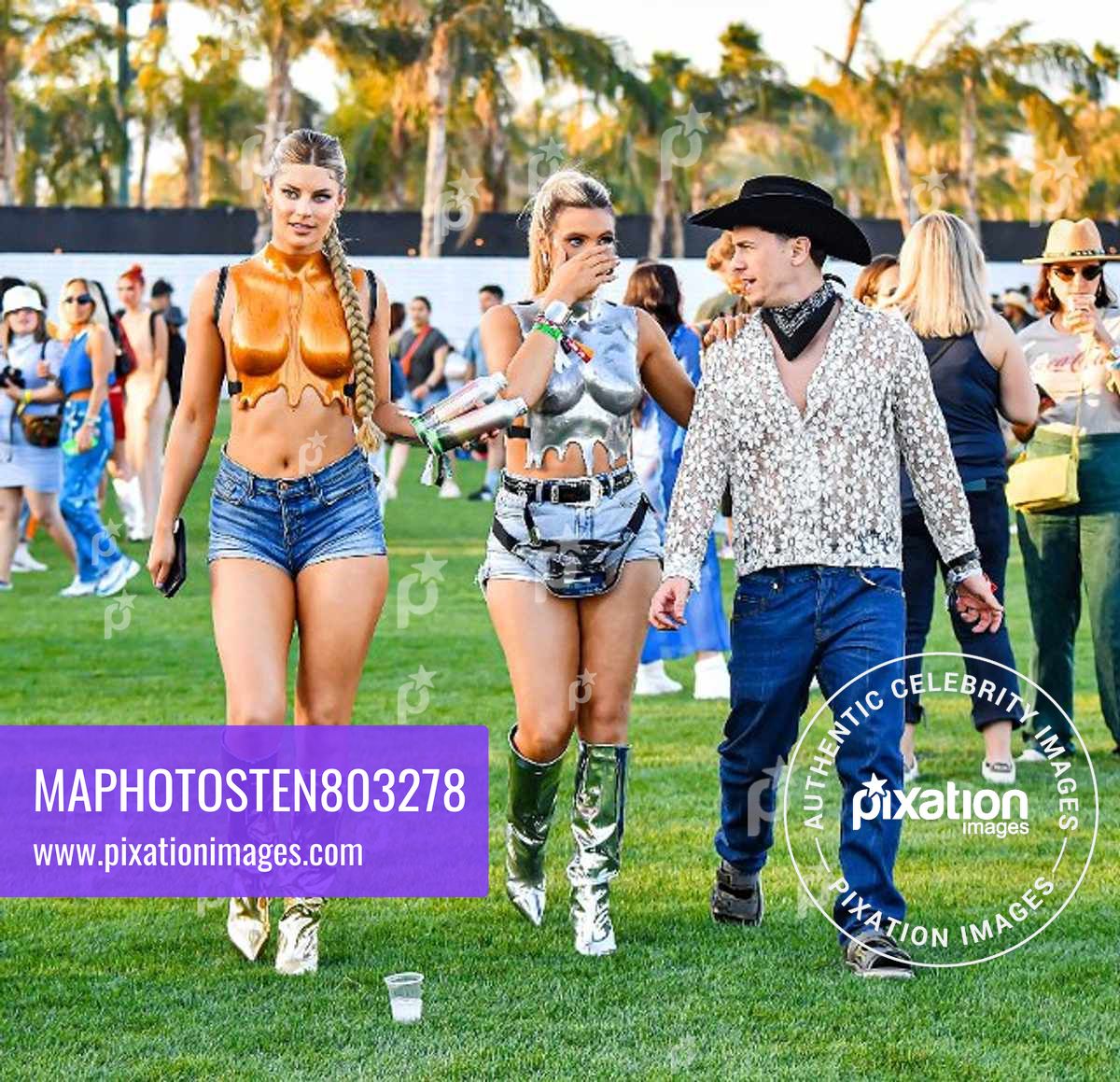 Lele Pons & Hannah Stocking Wear Matching Metallic Outfits While Attending The Coachella Music & Arts Festival in Indio, CA.