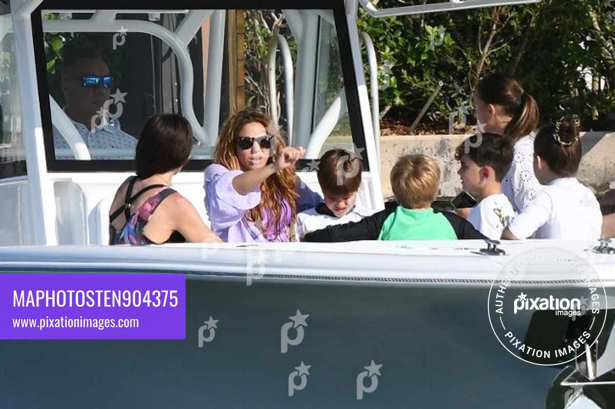 After mingling with Tom Cruise over F1 Weekend, Shakira looks happy as she takes an afternoon cruise with friends including F1 star Lewis Hamilton in Miami
