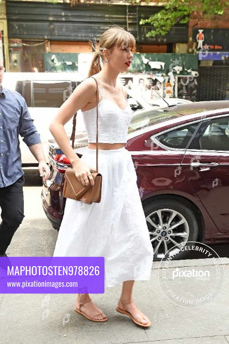 Taylor Swift looks angelic in a white crop top and a skirt while arriving to the Electric Lady recording studio